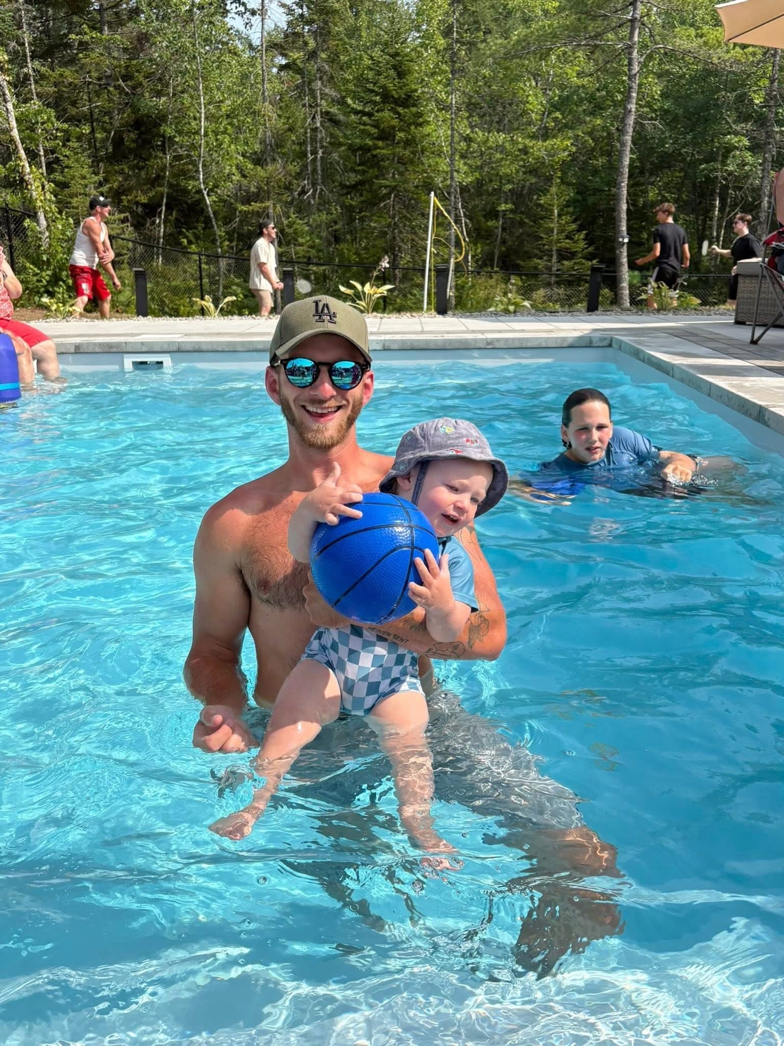 Spencer Book, owner of Ocean View Plunge Pools, with his son in a finished pool